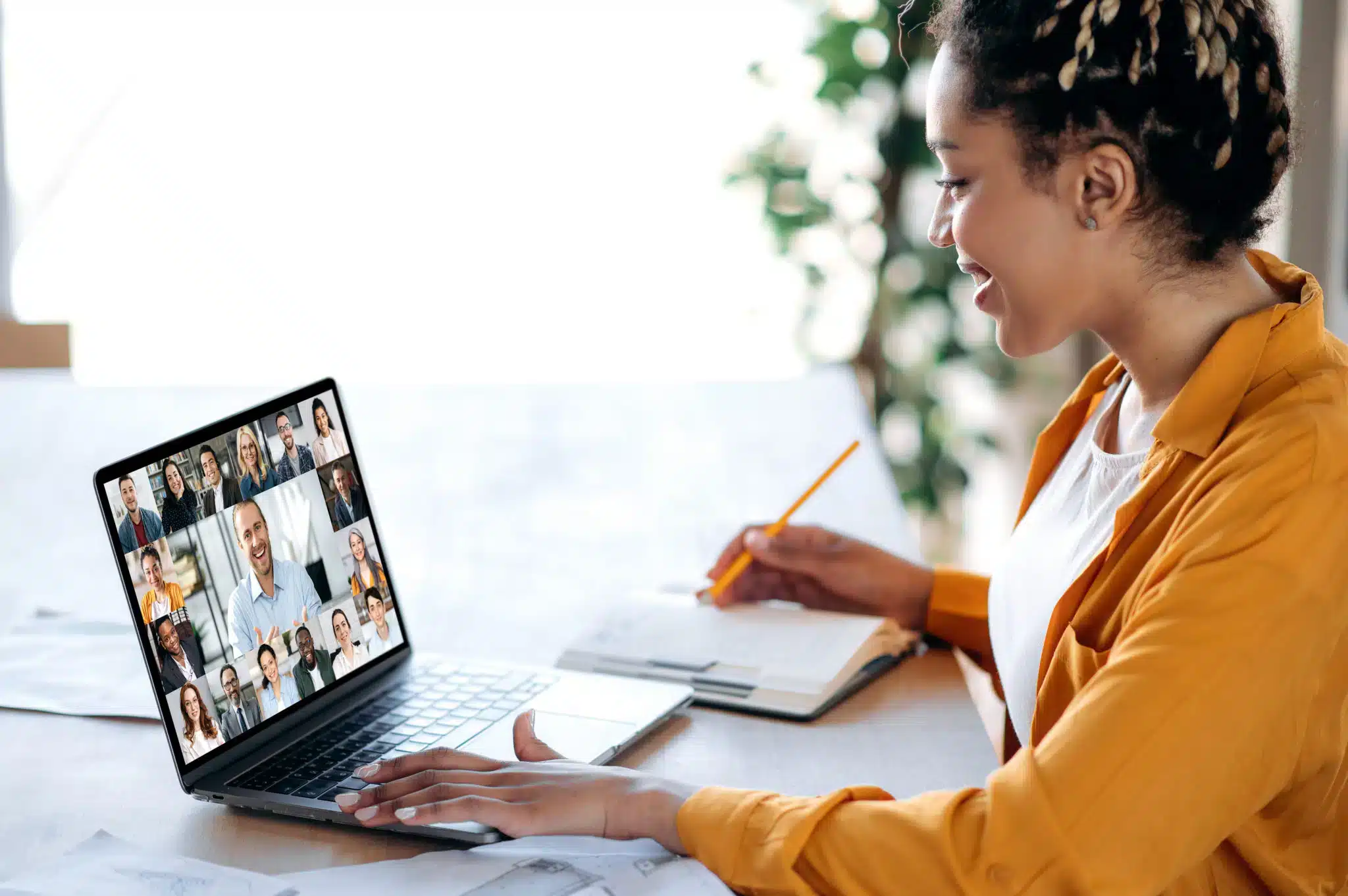 woman looking at a computer on a zoom call.